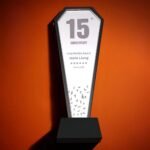 The trophy can be customized with text and is made of artificial black crystal and mirrored glass